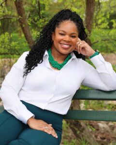 Smiling woman sitting on a park bench.